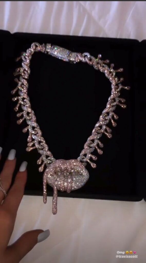 Travis Scott Gets Kylie Jenner Blinged Out Chain Featuring Kylie Cosmetics Logo